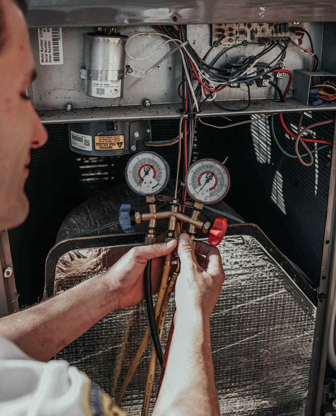 Milestone technician repairing an outdoor HVAC unit