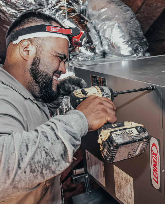 Milestone technician fixing an HVAC unit